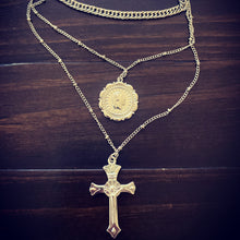 Load image into Gallery viewer, Cross & Coin Pendant Layered Necklace Master multi layered cross, coin pendant and chocker chain necklace. Trendy three layers with two stunning pendants. Available in silver and Gold. Chain 33 cm Coin 2 cm Chain 40 cm Cross 3.5 cm Chain 46 cm Please follow care instructions to maintain your pieces quality and integrity. #shopemmasofia