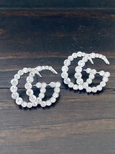 Load image into Gallery viewer, Strike Twinkle Studded Earrings. Make a statement with these stunning Designer Inspired studded earrings. Give any look that extra glam and shine it needs to twinkle like the stars! An Emma Sofia favorite. Available in Silver and Gold. 2.9 cm Please follow jewelry care instructions to maintain your pieces quality and integrity. #shopemmasofia