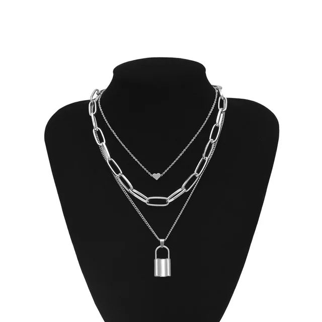 Lock and Heart Chain Layered Necklace.  Trendy layers with mini heart pendant, oval chain link and lock pendant. Every girls stable go to layering necklace. Available in Silver or Gold.   Heart 0.5 cm Chain 34.5 cm  Chain 42. cm  Lock 2.6 cm Chain 45.6 cm  Please follow care instructions to maintain your pieces quality and integrity. #shopemmasofia