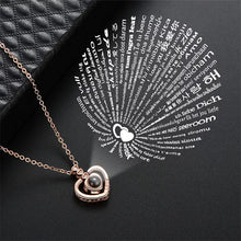 Load image into Gallery viewer, Beautiful stainless steel chain with cubic zirconia setting heart pendant that projects &quot;I love you&quot; in 100 languages visible up close or projected out above with flash light.   One of a kind gift for that special someone this Valentines, Anniversary or just because you want to say I you love in 100 different ways.  Chain 41 cm.  Pendant 1.7 cm.  Please follow care instructions to maintain your pieces quality and integrity. #ShopEmmaSofia
