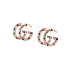 Load image into Gallery viewer, Strike Colored Studded Earring.  Strike a pose with our limited designer inspired color studded earrings. Mix and match your outfit of the day! Limited quantities. Available in Silver and Gold.  2 cm  Please follow care instructions to maintain your pieces quality and integrity. #SHOPEMMASOFIA
